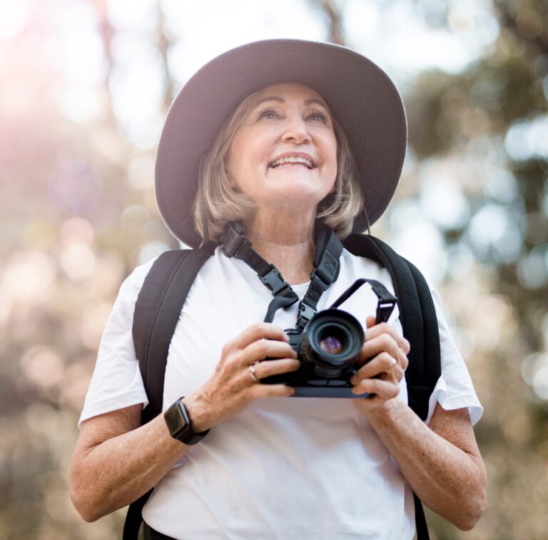 Senior lady taking pictures with a camera