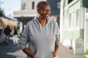 Thinking About Leaving the US? Smiling black woman outside.